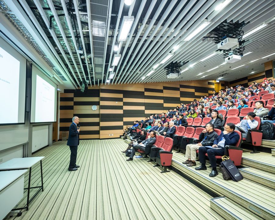 Delegates seated in a raked university lecture theatre during a conference session